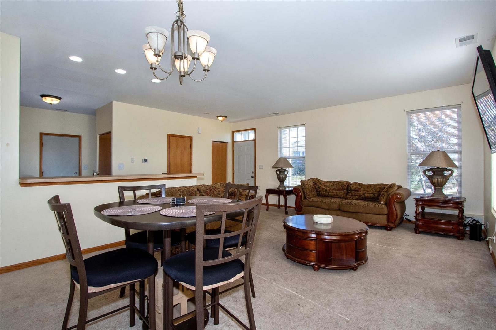 175 Springbrook Trail South Oswego, IL 60543 - Photo 5 of 25 a view of a dining room with furniture and a chandelier