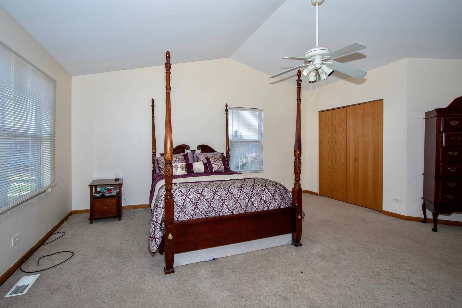 175 Springbrook Trail South Oswego, IL 60543 - Photo 9 of 25 a bedroom with a bed and a chandelier