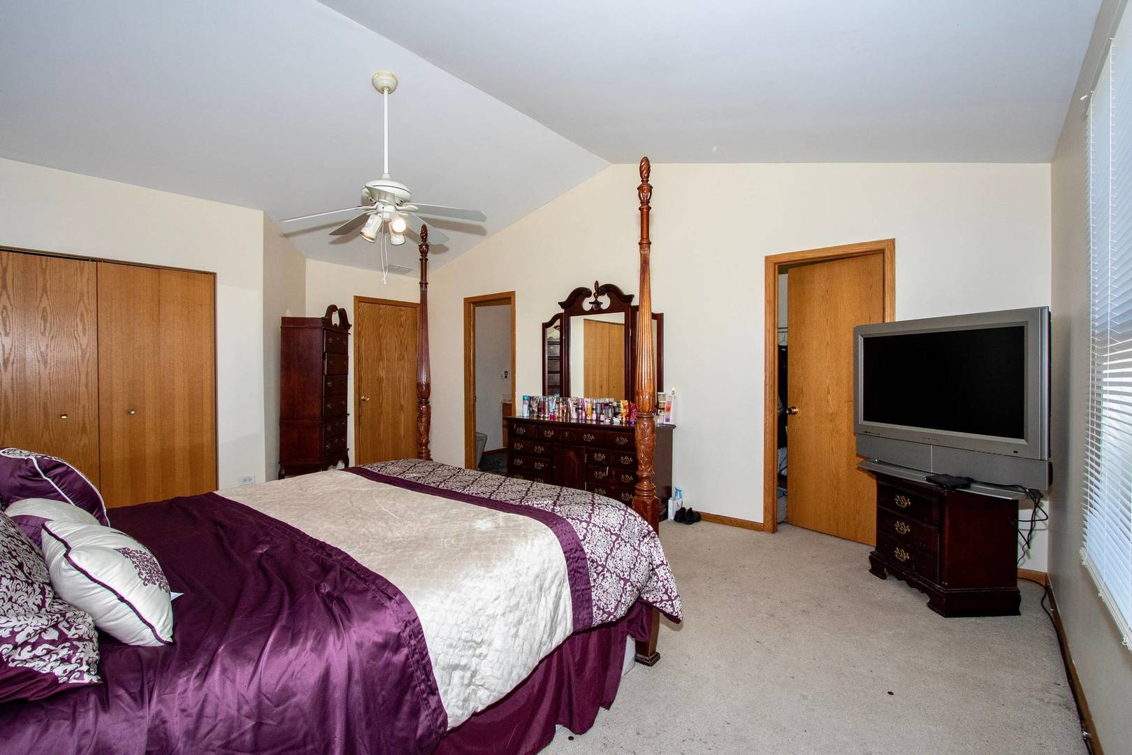 175 Springbrook Trail South Oswego, IL 60543 - Photo 10 of 25 a bedroom with a bed and a flat tv screen on wall