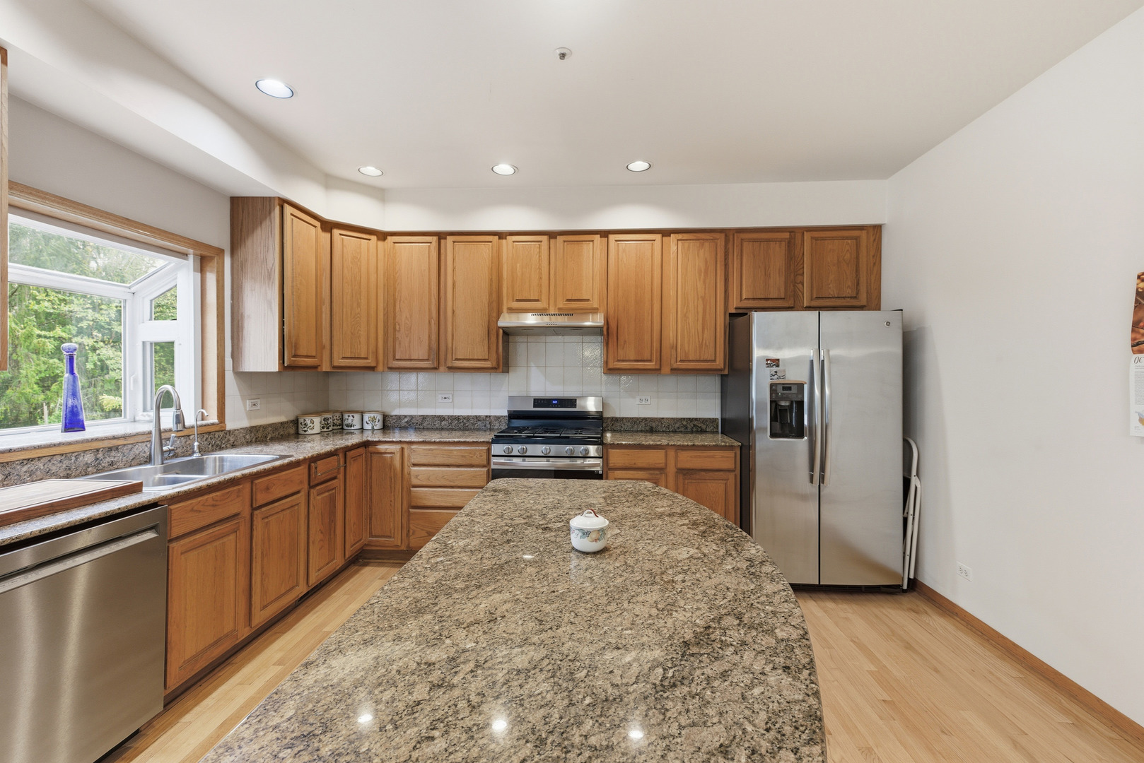 4420 Stonehaven Drive Long Grove, IL 60047 - Photo 15 of 59 a kitchen with stainless steel appliances granite countertop a stove a sink and a refrigerator