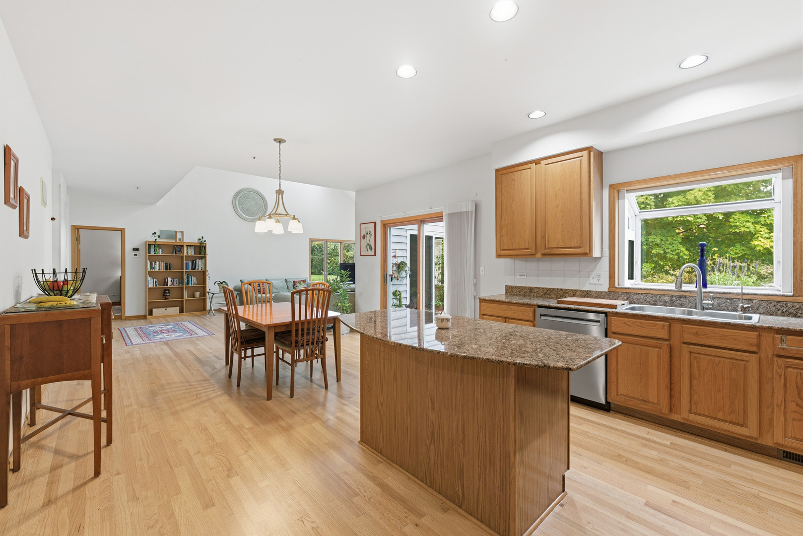 4420 Stonehaven Drive Long Grove, IL 60047 - Photo 18 of 59 a large kitchen with granite countertop a stove a sink a dining table and chairs