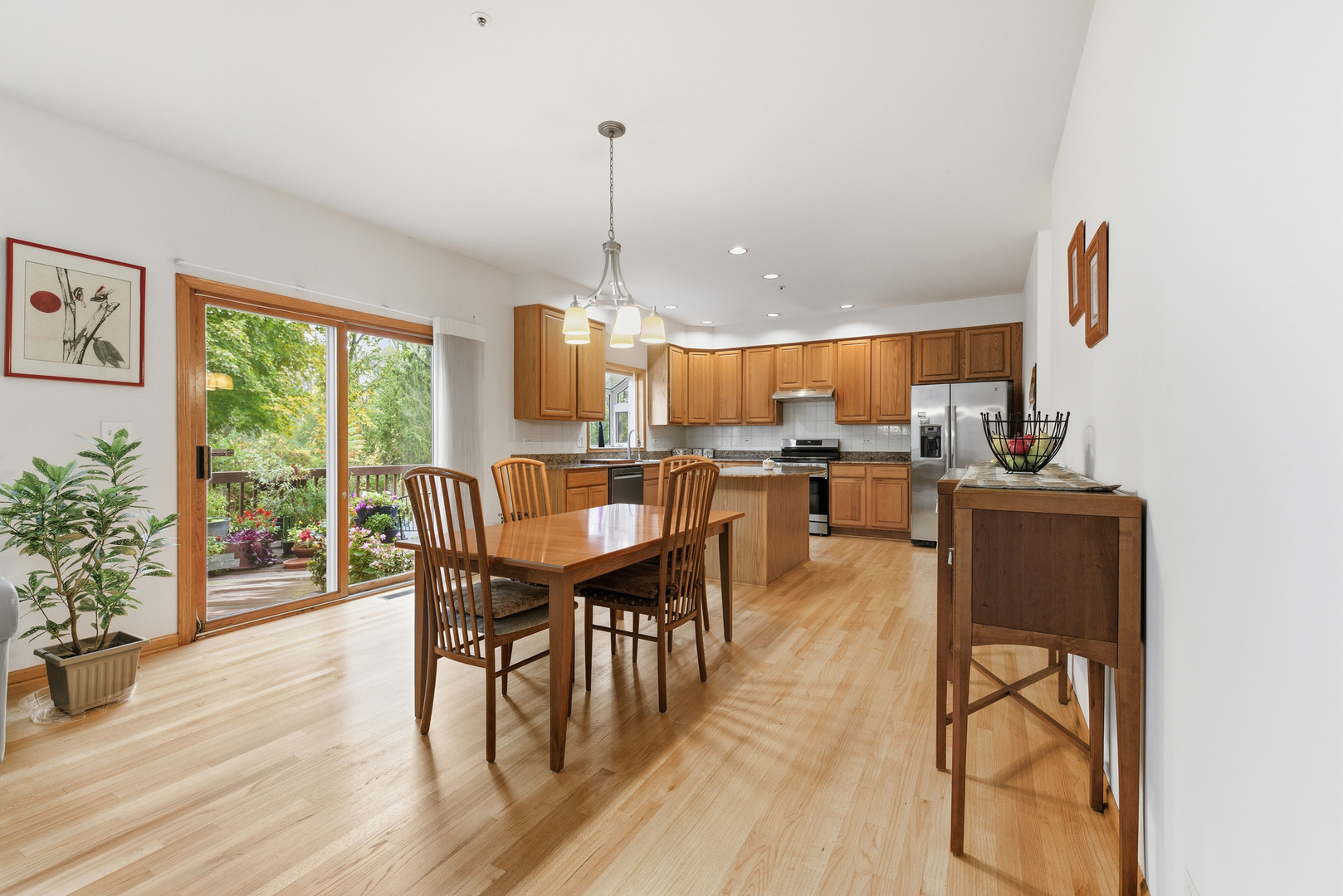 4420 Stonehaven Drive Long Grove, IL 60047 - Photo 23 of 59 a view of a dining room and livingroom with furniture wooden floor a chandelier