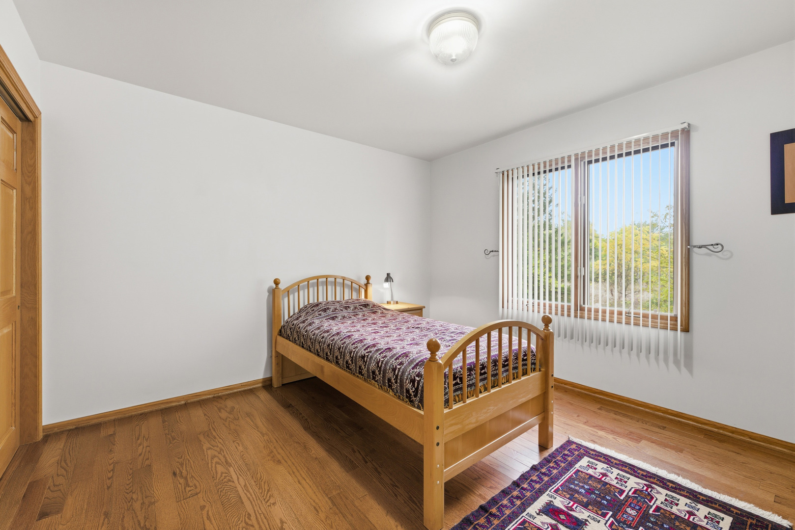 4420 Stonehaven Drive Long Grove, IL 60047 - Photo 39 of 59 a bedroom with a bed and wooden floor