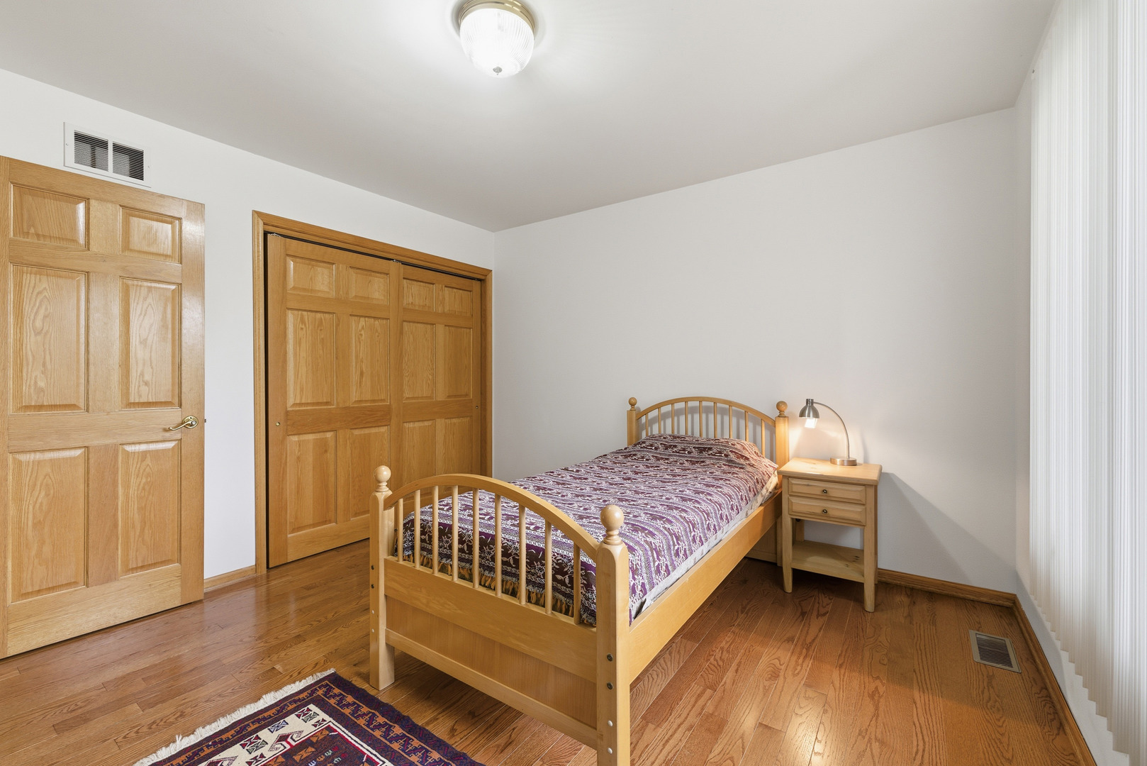 4420 Stonehaven Drive Long Grove, IL 60047 - Photo 40 of 59 a bedroom with a bed and wooden floor