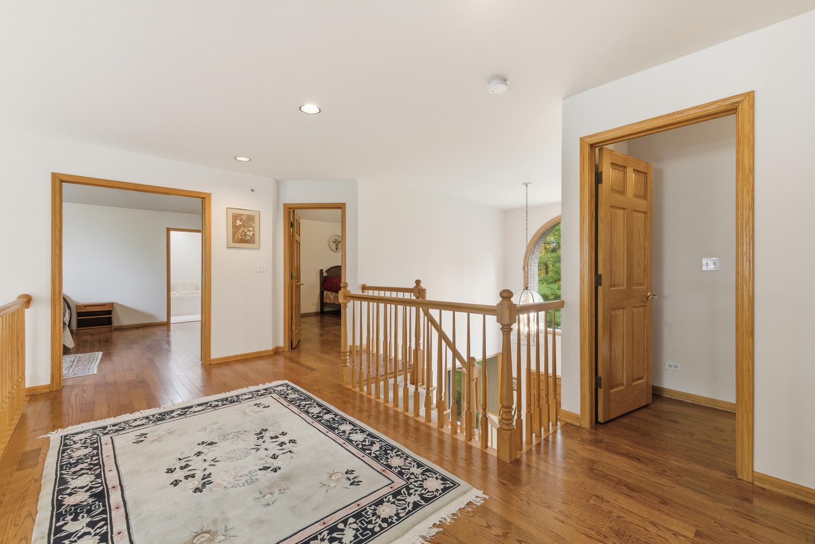 4420 Stonehaven Drive Long Grove, IL 60047 - Photo 44 of 59 a view of a hallway with wooden floor and a living room