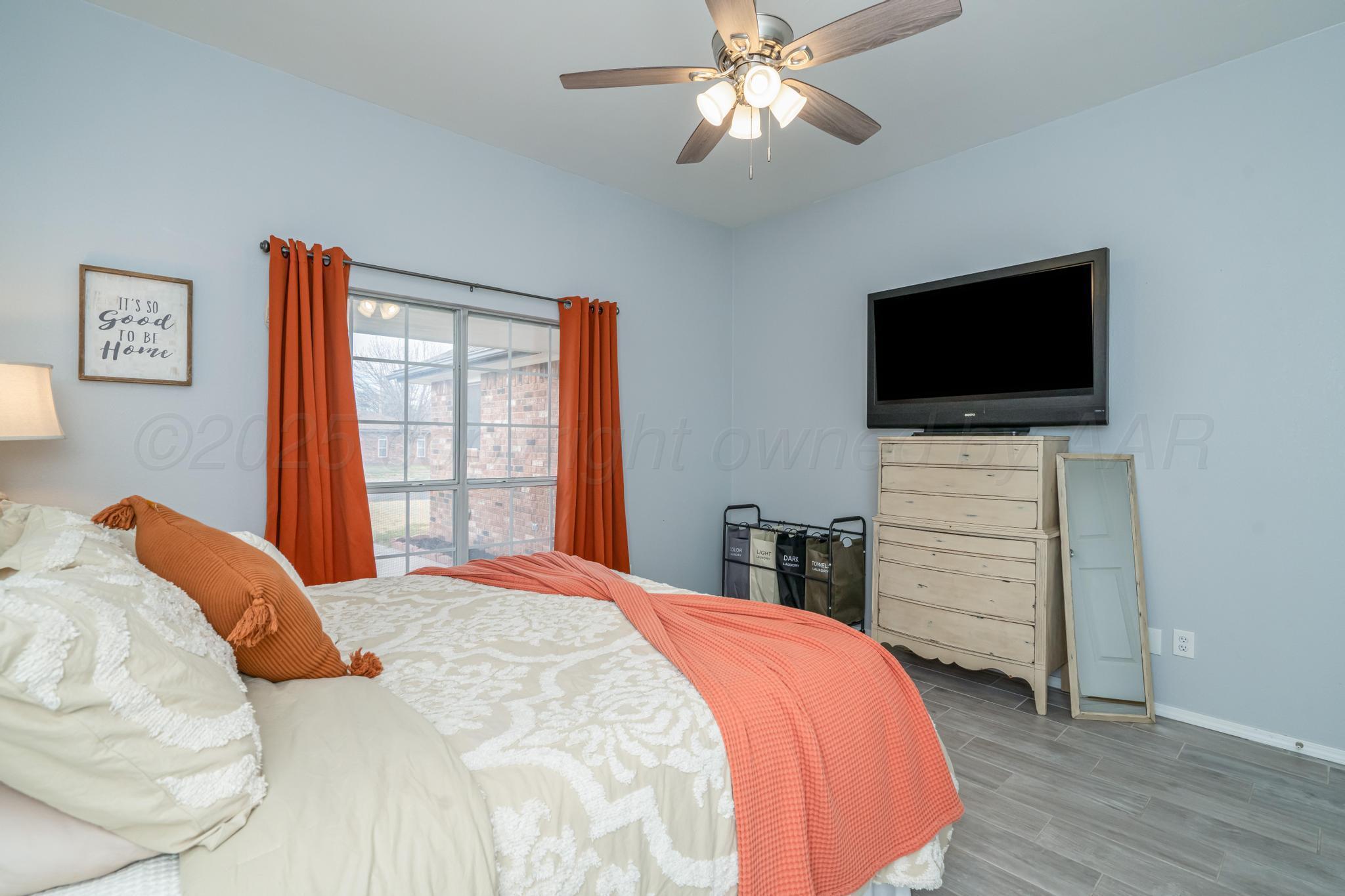2205 Troveta Drive Amarillo, TX 79110 - Photo 13 of 28 a bedroom with a bed and a flat screen tv