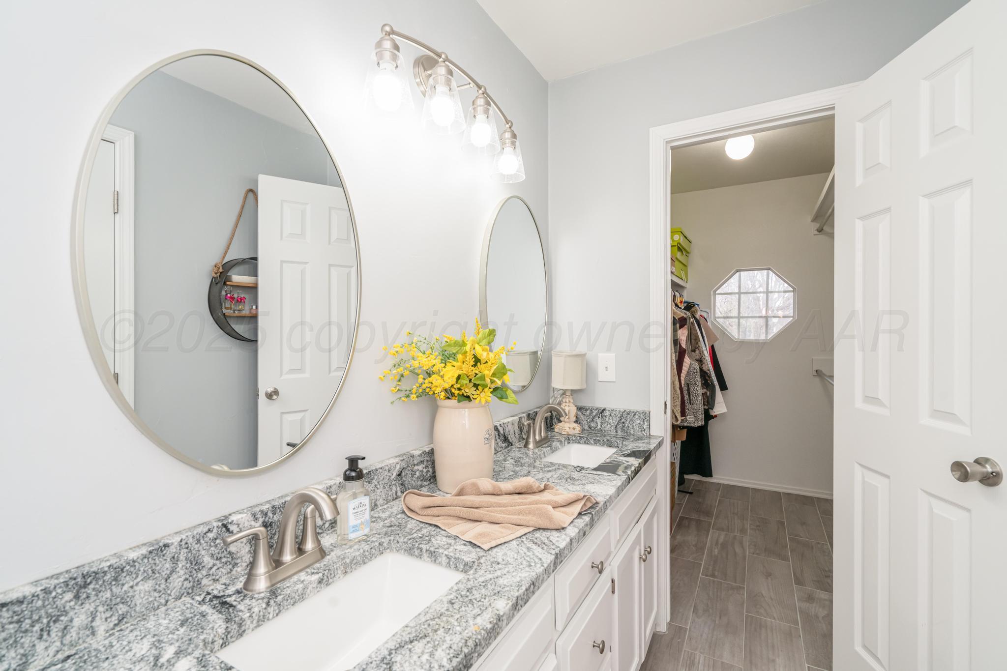 2205 Troveta Drive Amarillo, TX 79110 - Photo 15 of 28 a bathroom with a granite countertop sink and a mirror
