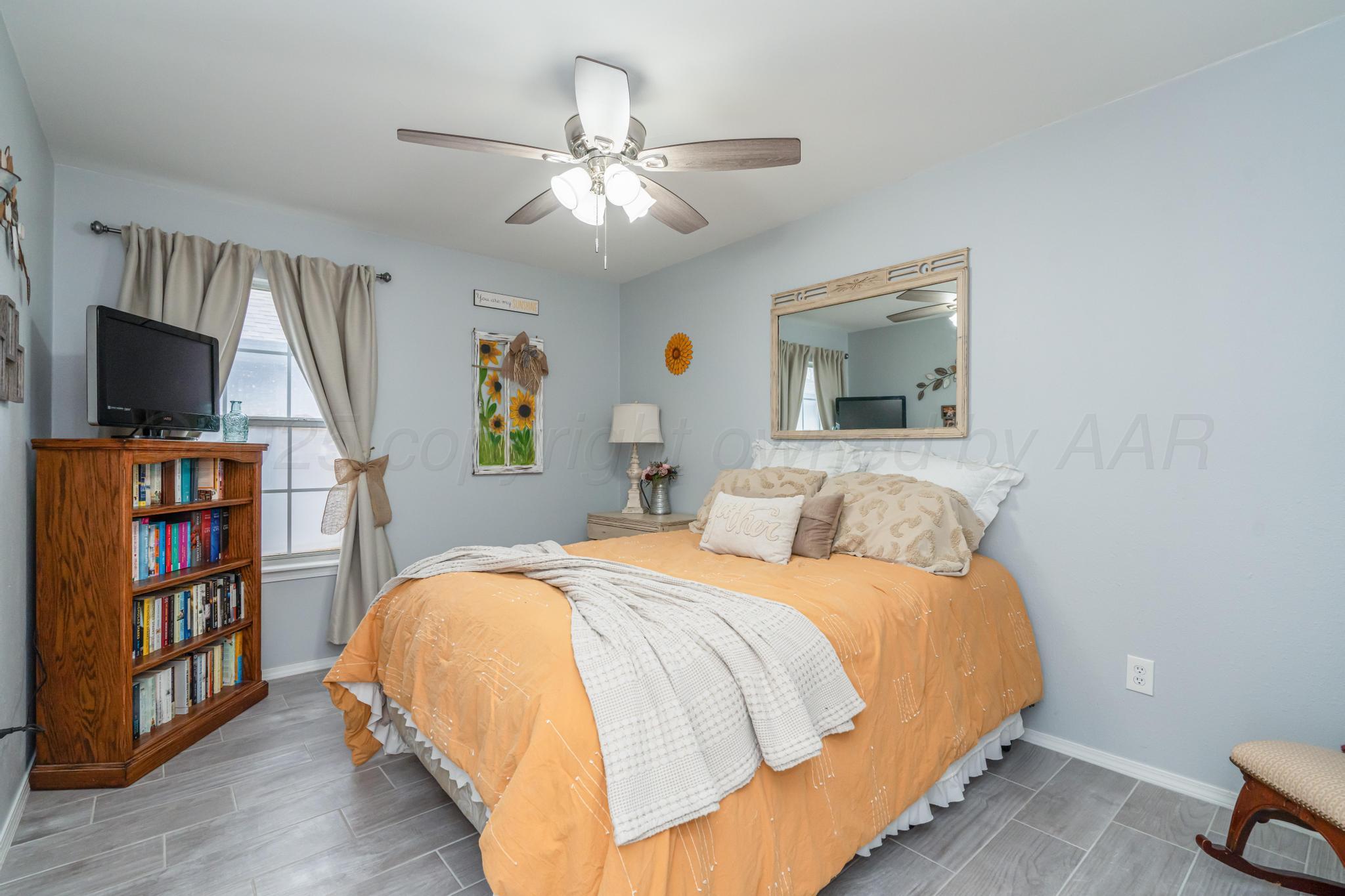 2205 Troveta Drive Amarillo, TX 79110 - Photo 17 of 28 a bedroom with a bed and a flat screen tv
