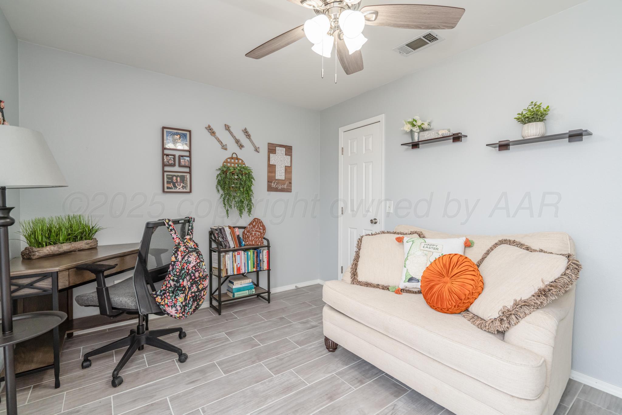 2205 Troveta Drive Amarillo, TX 79110 - Photo 19 of 28 a living room with furniture and a chandelier