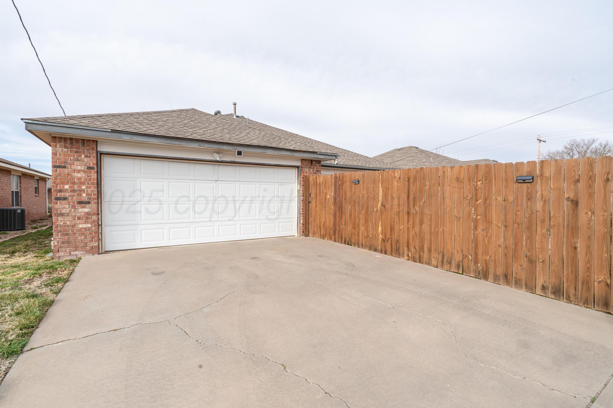 2205 Troveta Drive Amarillo, TX 79110 - Photo 26 of 28 a front view of a house with a yard and garage