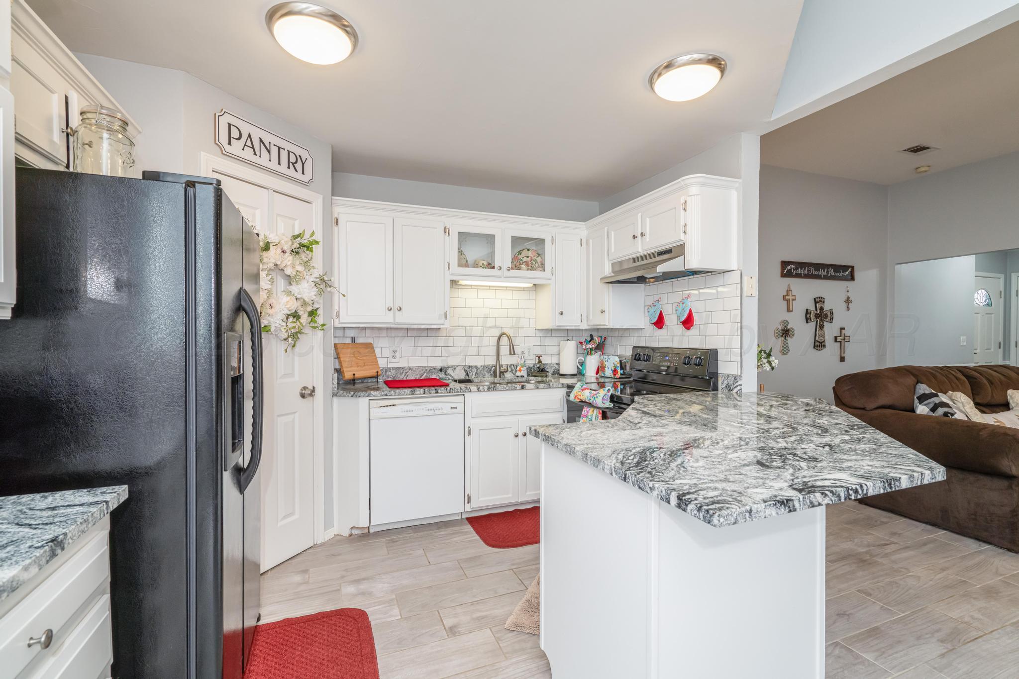 2205 Troveta Drive Amarillo, TX 79110 - Photo 3 of 28 a kitchen with stainless steel appliances granite countertop a refrigerator sink stove and cabinets