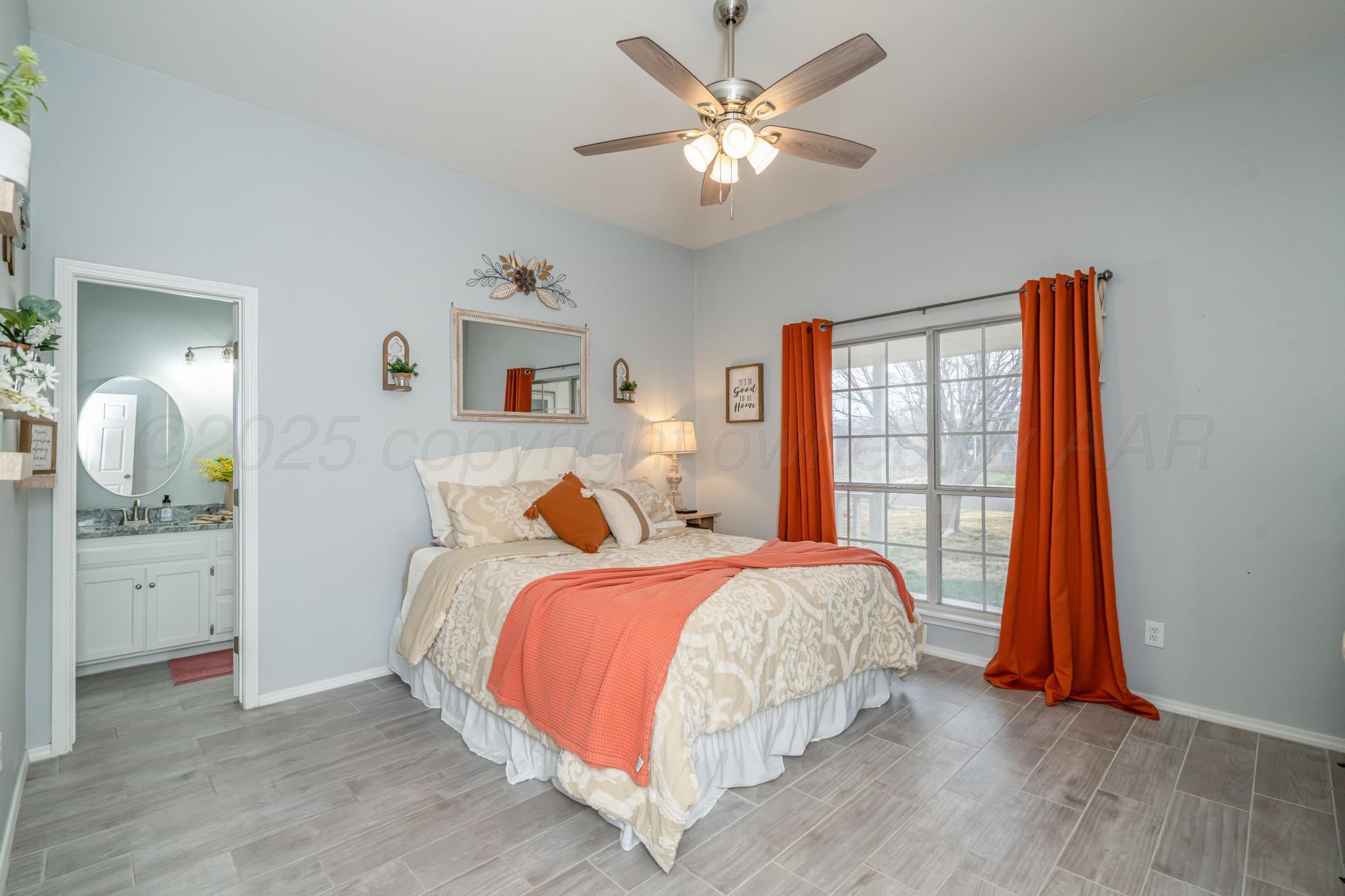 2205 Troveta Drive Amarillo, TX 79110 - Photo 5 of 28 a bedroom with a bed and a chandelier