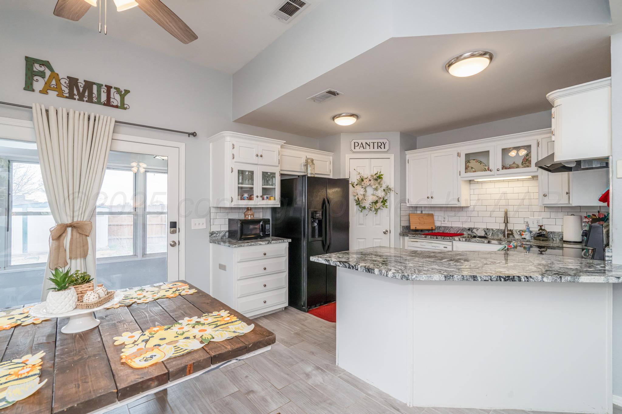 2205 Troveta Drive Amarillo, TX 79110 - Photo 6 of 28 a kitchen with stainless steel appliances granite countertop a refrigerator and stove