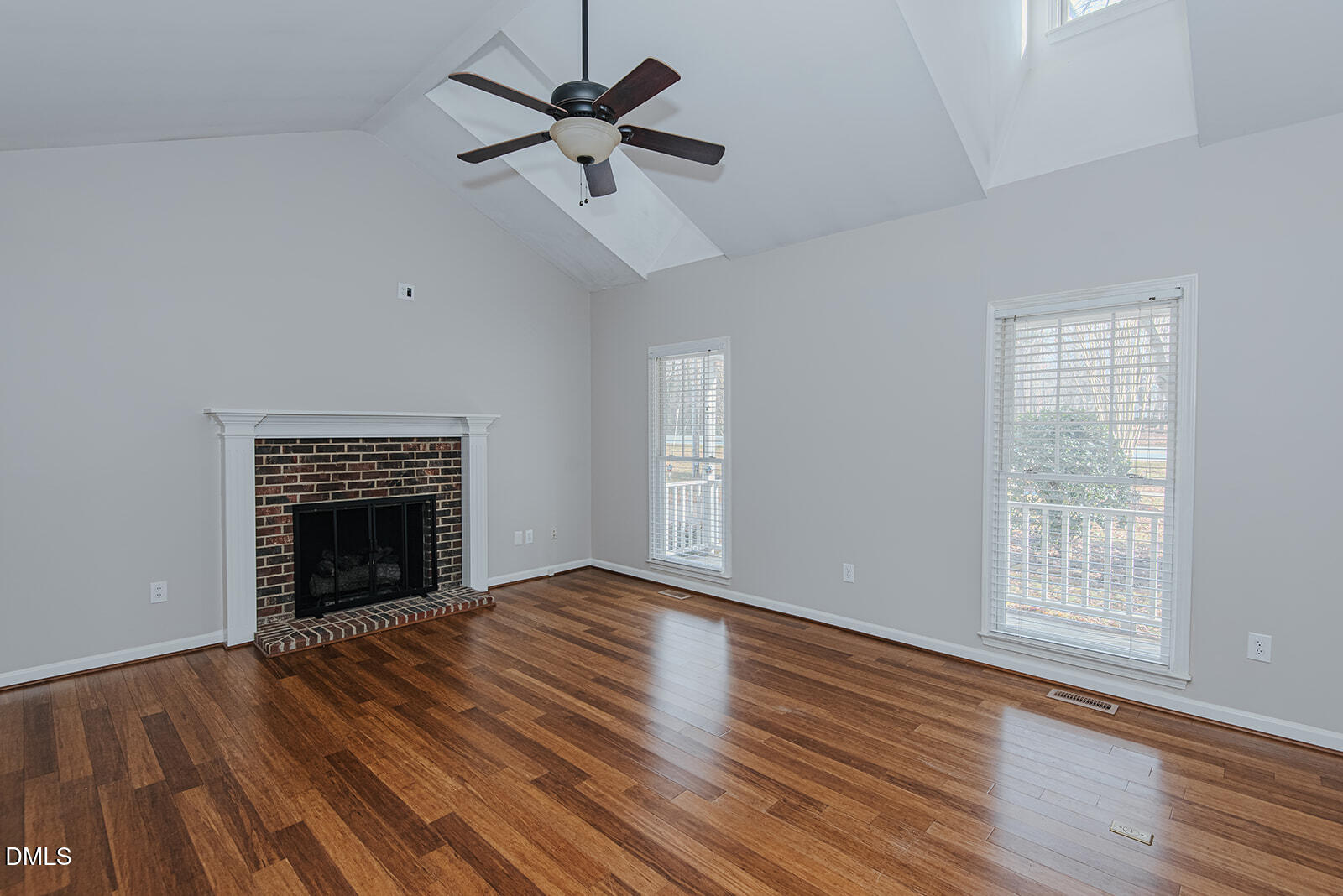 802 South Third Street Mebane, NC 27302 - Photo 12 of 41 an empty room with windows fireplace and wooden floor