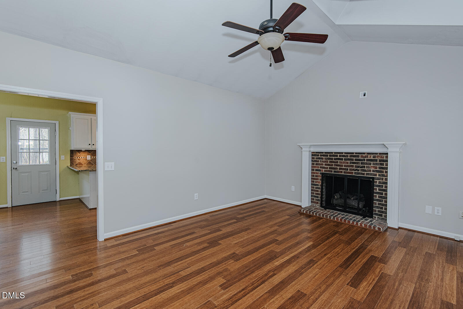 802 South Third Street Mebane, NC 27302 - Photo 15 of 41 an empty room with wooden floor a fireplace and windows