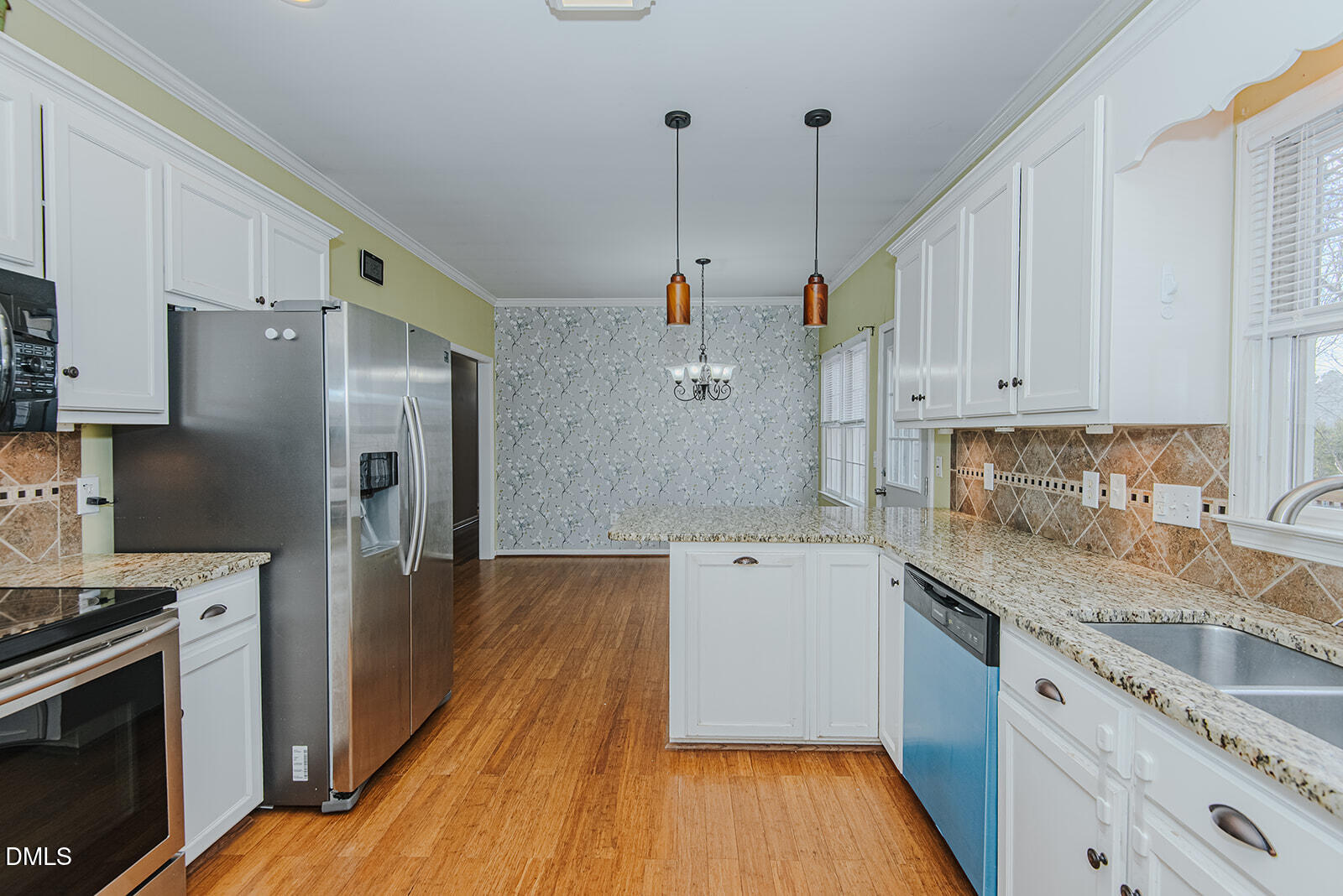 802 South Third Street Mebane, NC 27302 - Photo 4 of 41 a kitchen with a refrigerator a sink and wooden floor