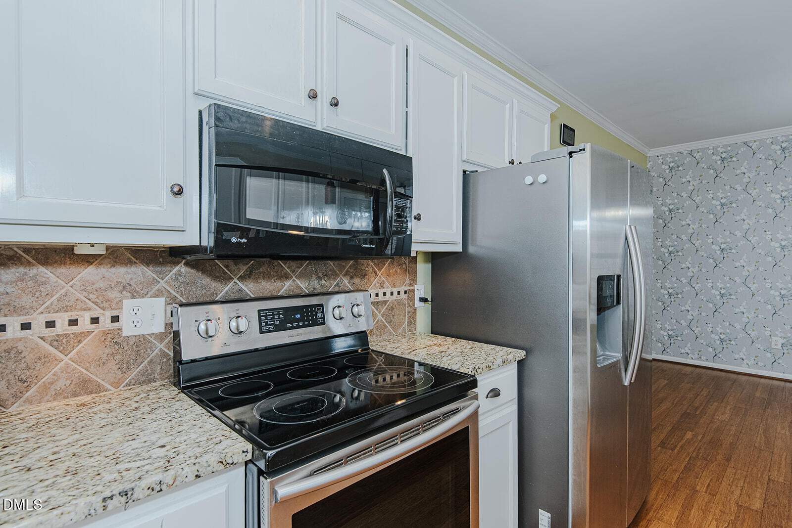 802 South Third Street Mebane, NC 27302 - Photo 8 of 41 a kitchen with granite countertop cabinets stainless steel appliances and wooden floor
