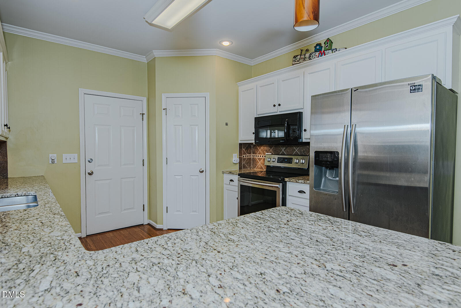 802 South Third Street Mebane, NC 27302 - Photo 9 of 41 a kitchen with granite countertop a refrigerator and a sink