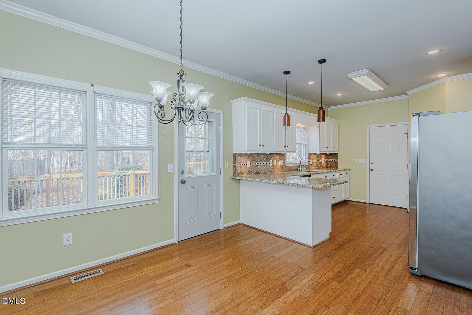 802 South Third Street Mebane, NC 27302 - Photo 10 of 41 a kitchen with stainless steel appliances granite countertop a refrigerator a sink dishwasher a stove and white cabinets with wooden floor