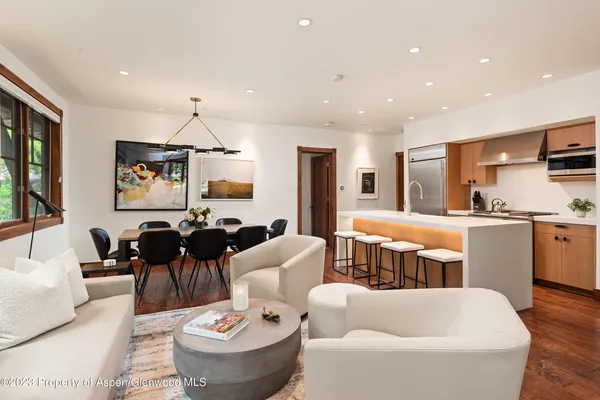 a living room with furniture and kitchen view