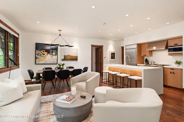 a living room with furniture and kitchen view