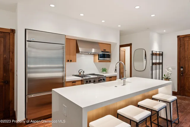 a large kitchen with a table and chairs