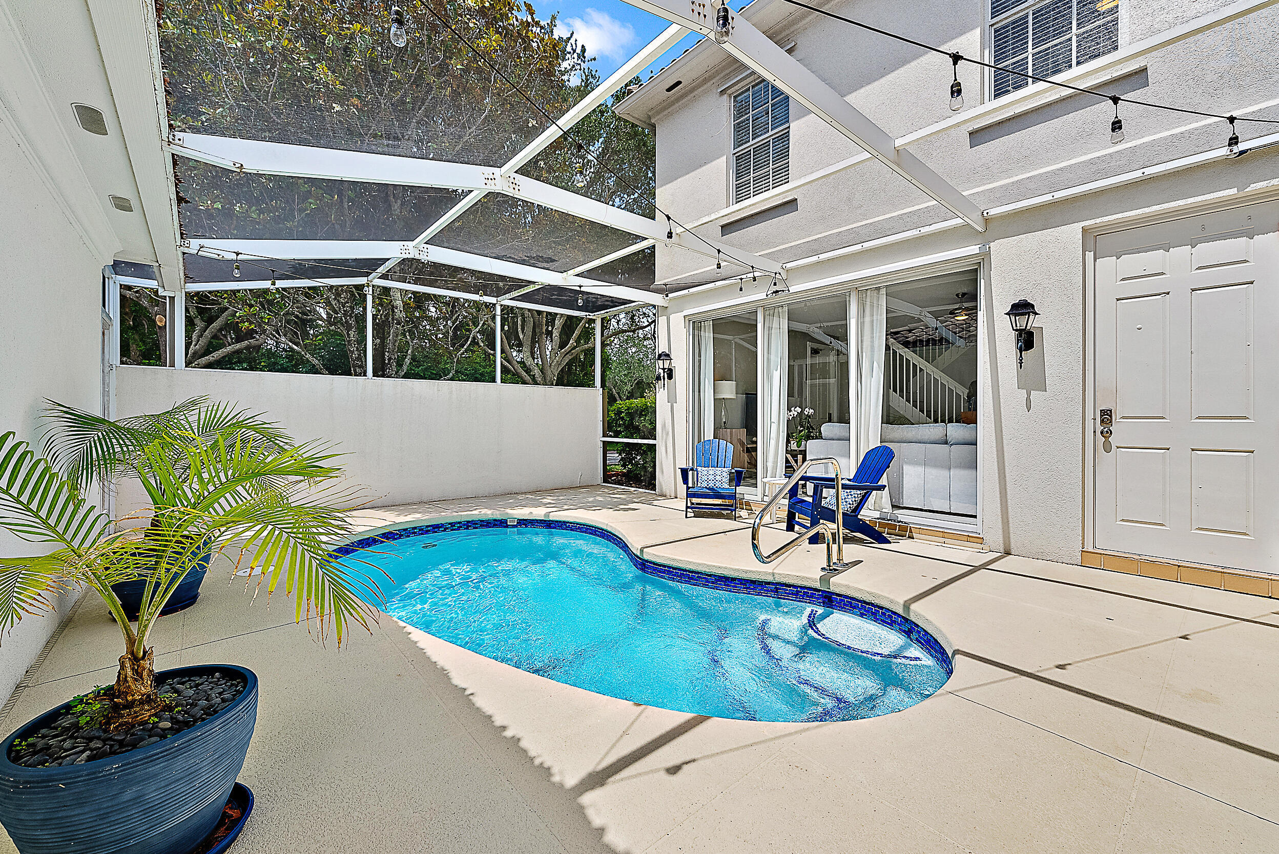 107 Rivinia Drive Jupiter, FL 33458 - Photo 1 of 28 a view of a swimming pool with potted plants