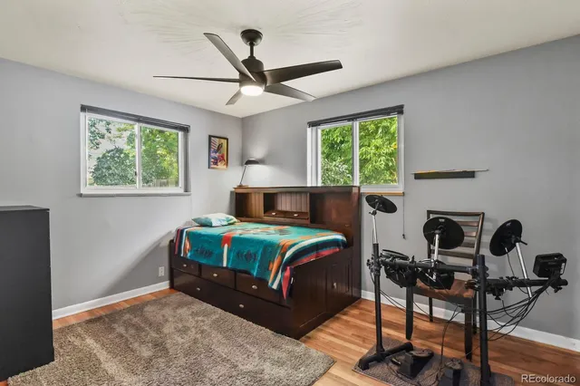 a bedroom with a bed a window and a chandelier
