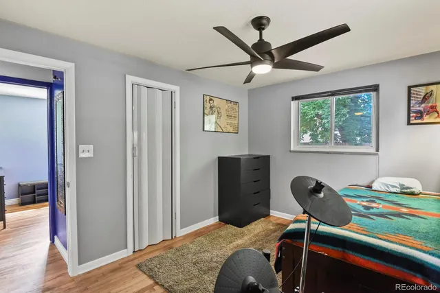 a bedroom that has a bed and a desk in it