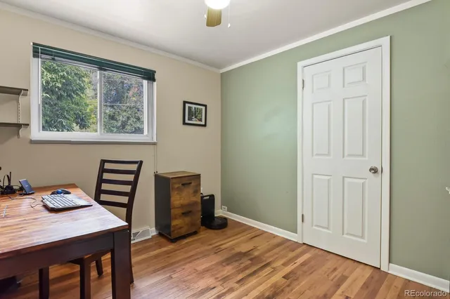 a view of a workspace with furniture and a window