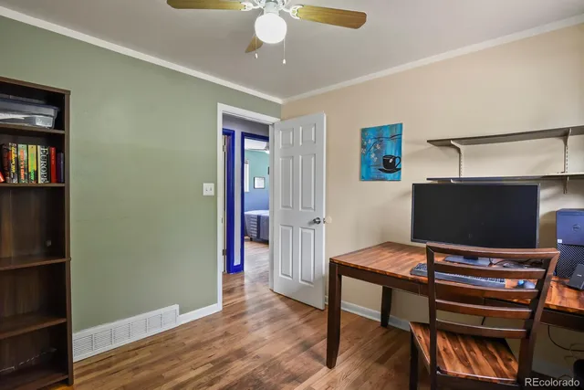 a view of a workspace with furniture and wooden floor