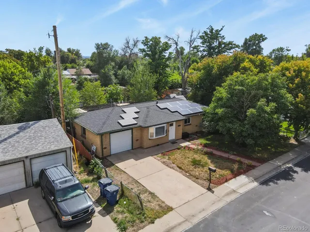 an aerial view of a house with swimming pool garden and patio
