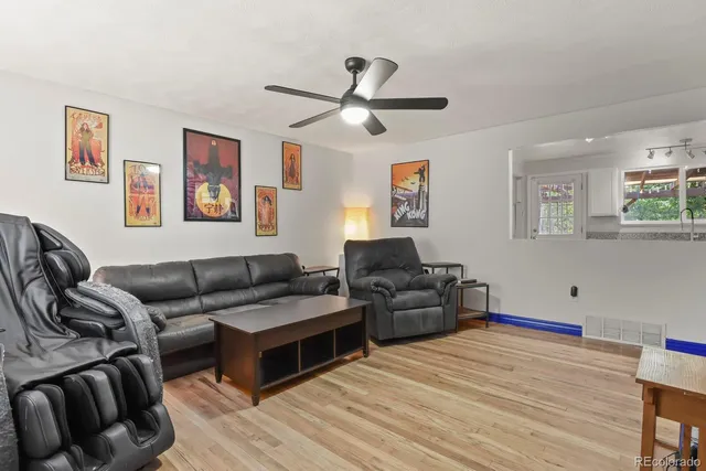 a living room with furniture and painting on the wall