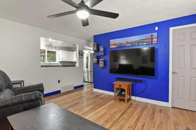 a living room with pool table and a flat screen tv