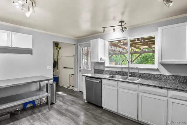 a kitchen with a sink stove and cabinets