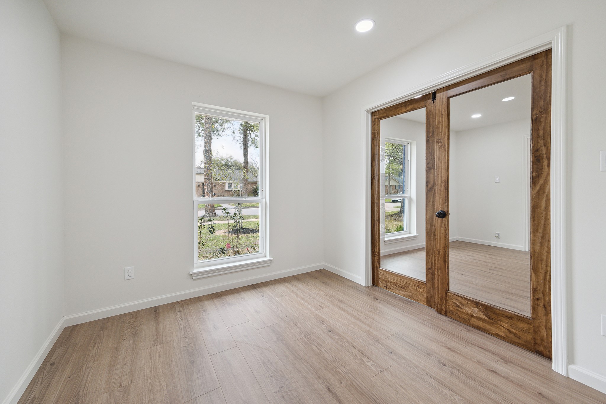 9719 Springmont Drive Houston, TX 77080 - Photo 6 of 32 In the bonus/flex room, glass doors keep the spaces connected, but the glass can be easily frosted for privacy! There is also a full-sized closet in this room!