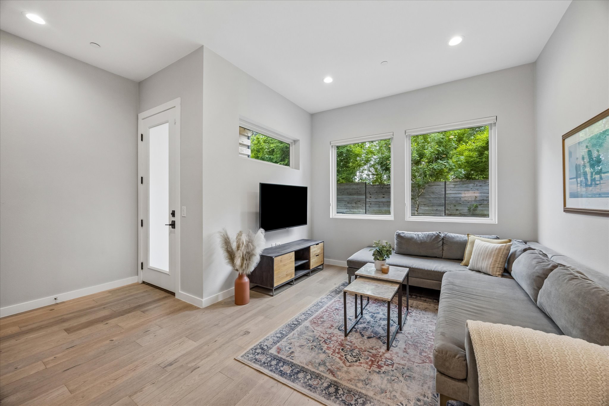 2108 Tillery Street, Unit 9 Austin, TX 78723 - Photo 9 of 25 Light-filled living room with large picture windows overlooking backyard