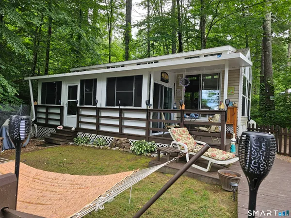 a view of a house with backyard and sitting area