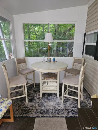 a view of a dining room with furniture window and outside view