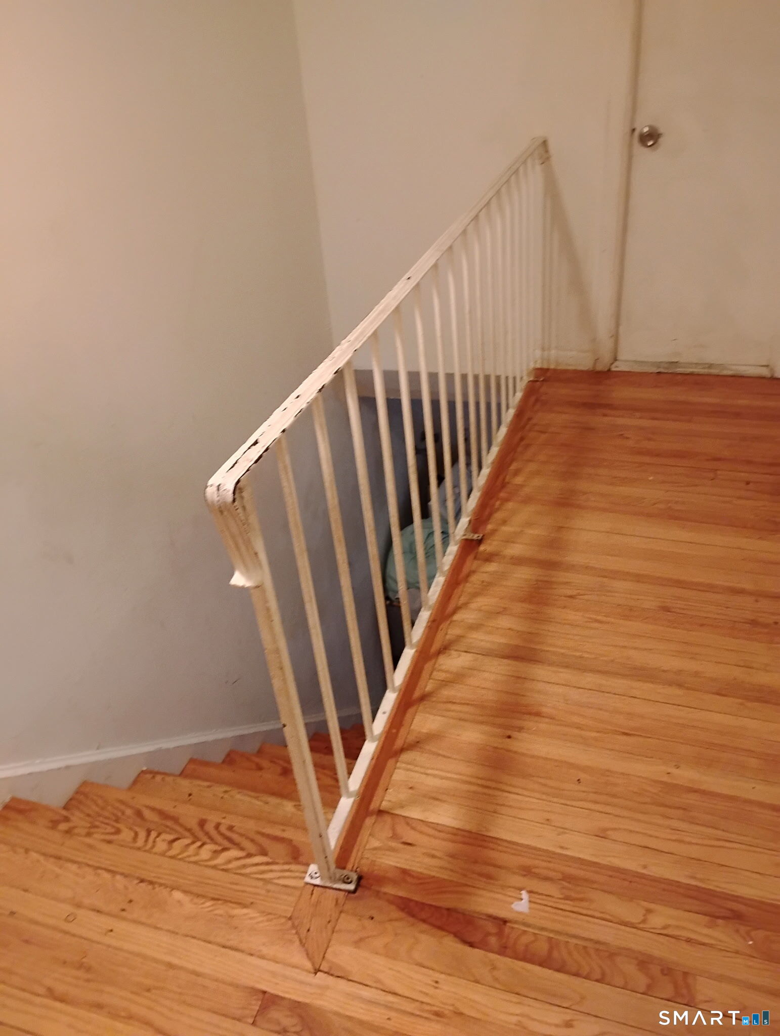 341 Mill Rock Road, Unit 341 Hamden, CT 06517 - Photo 4 of 9 a view of a hallway with wooden floor