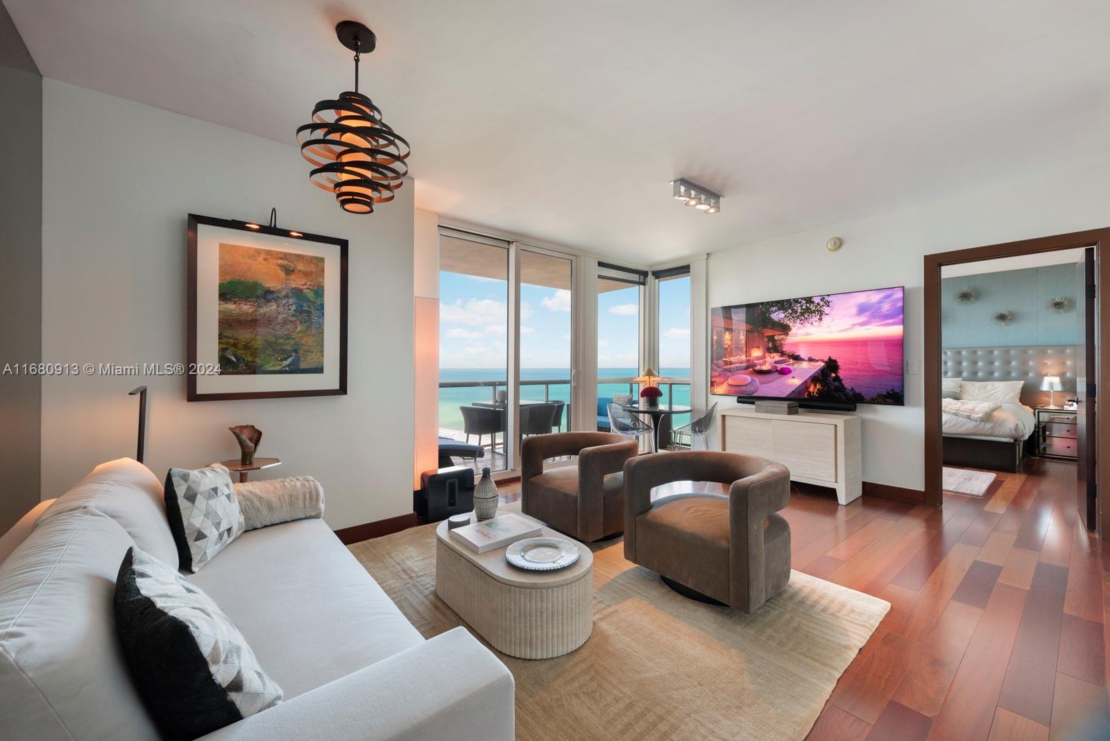 101 20th Street, Unit 2603 Miami Beach, FL 33139 - Photo 1 of 16 a living room with furniture and a flat screen tv