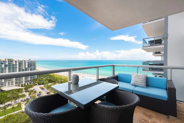 a balcony with an outdoor seating