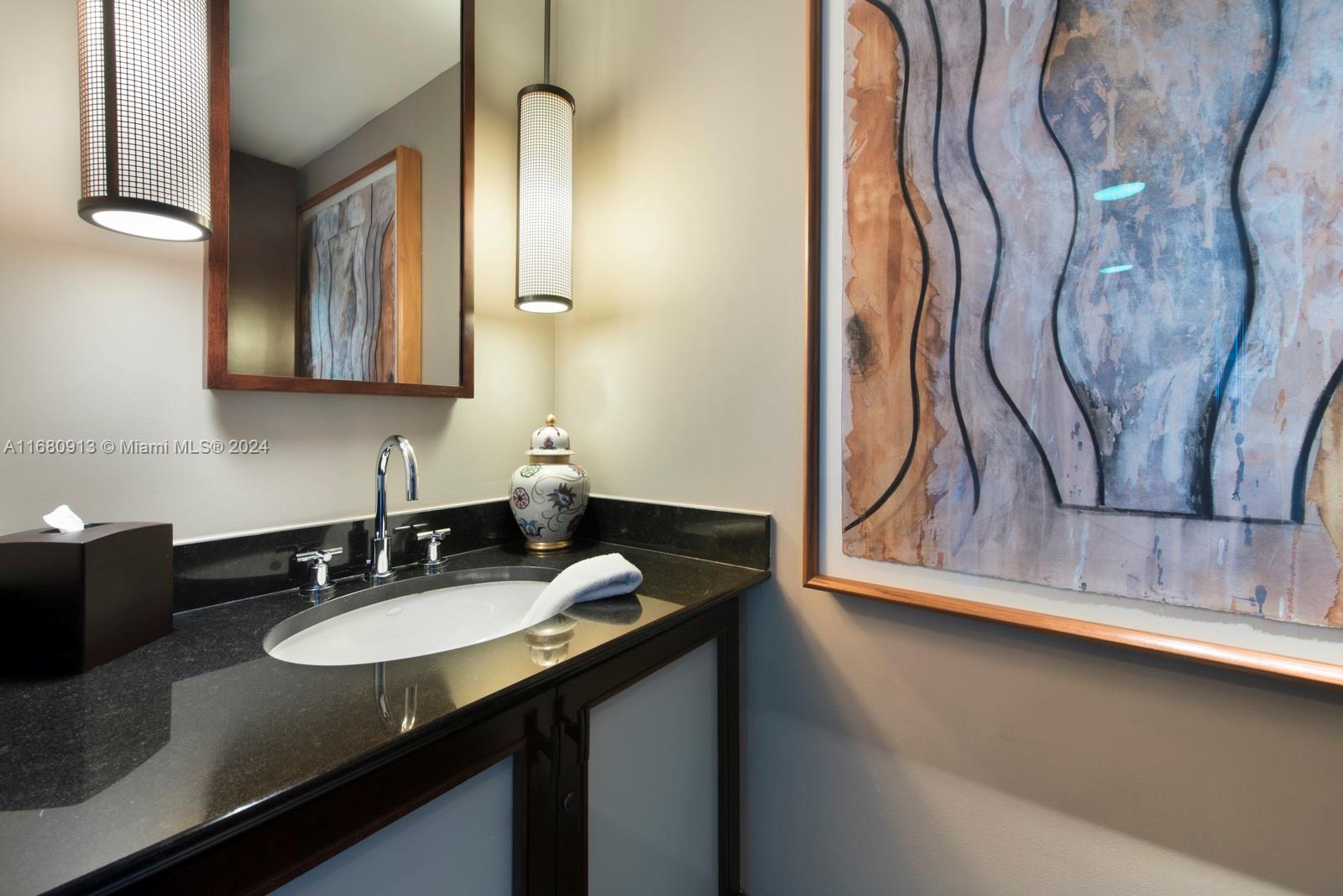 101 20th Street, Unit 2603 Miami Beach, FL 33139 - Photo 15 of 16 a bathroom with a sink and a mirror