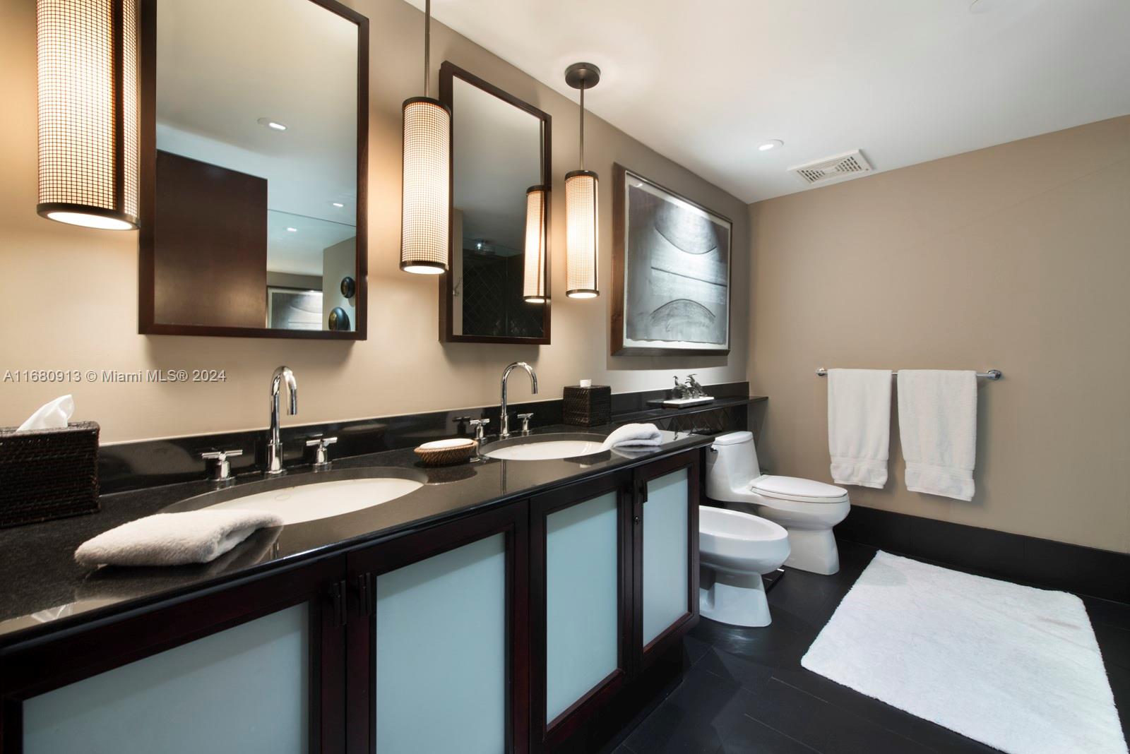 101 20th Street, Unit 2603 Miami Beach, FL 33139 - Photo 16 of 16 a bathroom with a double vanity sink and a mirror