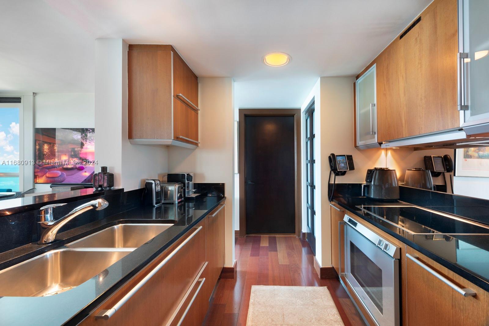 101 20th Street, Unit 2603 Miami Beach, FL 33139 - Photo 5 of 16 a kitchen that has a sink and a stove