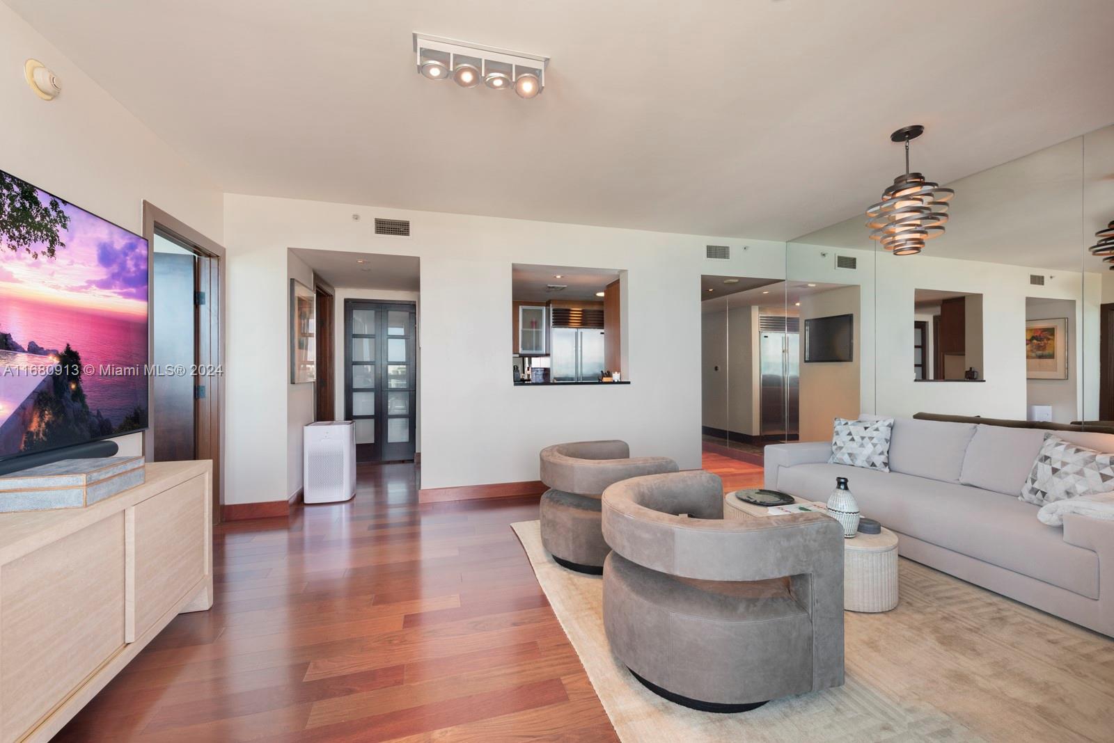 101 20th Street, Unit 2603 Miami Beach, FL 33139 - Photo 7 of 16 a living room with furniture and a flat screen tv