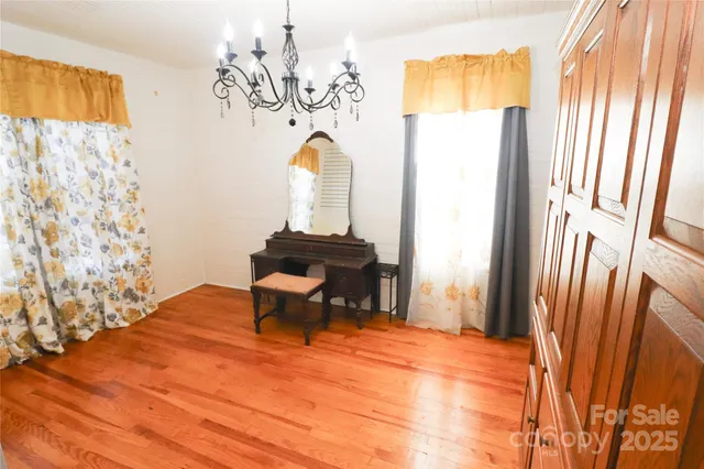 a dining room with a window and a chandelier