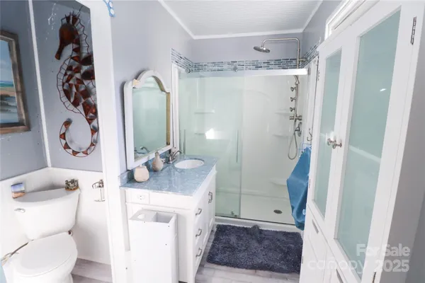 a bathroom with a sink a toilet and shower