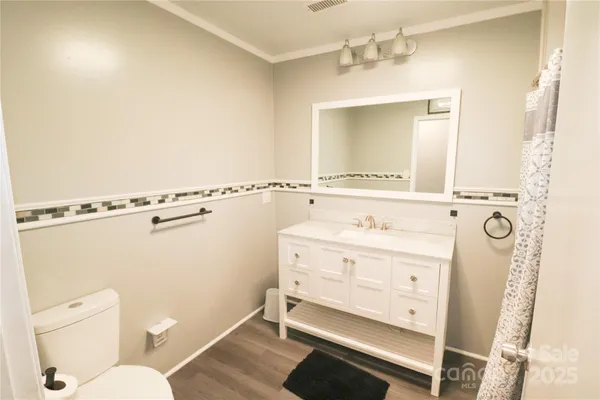 a bathroom with a sink a mirror and a toilet