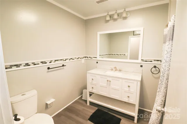 a bathroom with a sink a mirror and a toilet